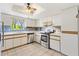 Bright kitchen with stainless steel appliances, white cabinetry, and tiled floors at 17915 Se 102Nd Ter, Summerfield, FL 34491