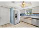 Well-equipped kitchen featuring stainless steel appliances, white cabinets, and ample countertop space at 17915 Se 102Nd Ter, Summerfield, FL 34491
