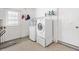 Well-lit laundry room equipped with washer, dryer, and storage shelves at 17915 Se 102Nd Ter, Summerfield, FL 34491