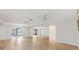 Bright living room features hardwood floors, ceiling fan and mirrored wall at 17915 Se 102Nd Ter, Summerfield, FL 34491