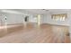 Light-filled living room with hardwood floors and expansive mirrored wall at 17915 Se 102Nd Ter, Summerfield, FL 34491