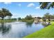 Scenic pond view featuring a gazebo, fountain, and lush green surroundings on a sunny day at 17915 Se 102Nd Ter, Summerfield, FL 34491