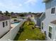 Aerial view of a backyard featuring a pool, sitting area, swing set, and a manicured lawn at 1906 Se 28Th Pl, Ocala, FL 34471