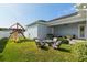 Backyard featuring a fire pit with chairs and a wooden playset with a slide at 1906 Se 28Th Pl, Ocala, FL 34471