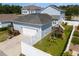 Aerial view of the backyard with a swing set, white fence, and manicured lawn, with basketball hoop in driveway at 1906 Se 28Th Pl, Ocala, FL 34471