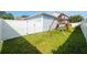 Backyard with a wooden playground set and a well-maintained lawn at 1906 Se 28Th Pl, Ocala, FL 34471