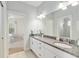 Bathroom featuring a dual sink vanity with granite countertop and shower with glass door at 1906 Se 28Th Pl, Ocala, FL 34471