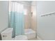 Bathroom featuring a white bathtub with a blue and white striped shower curtain at 1906 Se 28Th Pl, Ocala, FL 34471