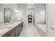 Bathroom boasts double vanity, granite counters, soaking tub, walk-in shower, and walk-in closet at 1906 Se 28Th Pl, Ocala, FL 34471