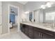 Bathroom boasts double vanity, granite counters, large mirror and easy access to the main bedroom at 1906 Se 28Th Pl, Ocala, FL 34471