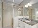 Bathroom featuring granite vanity, white cabinets, and a walk-in shower with glass enclosure at 1906 Se 28Th Pl, Ocala, FL 34471