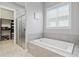 Soaking tub and walk in shower with tile surround at 1906 Se 28Th Pl, Ocala, FL 34471