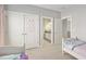 Bedroom with closet and bathroom access featuring two twin beds with cozy decor at 1906 Se 28Th Pl, Ocala, FL 34471