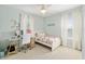 Bedroom with carpeted floors, bright natural light, and a modern glass desk with white chair at 1906 Se 28Th Pl, Ocala, FL 34471