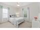 Comfortable bedroom with bright windows, a ceiling fan, and neutral carpeting at 1906 Se 28Th Pl, Ocala, FL 34471