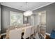 Well-lit dining area featuring a large window and seating for eight at 1906 Se 28Th Pl, Ocala, FL 34471