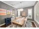 Stylish dining room with chandelier, hardwood floors, and gray walls at 1906 Se 28Th Pl, Ocala, FL 34471
