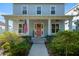 Inviting covered front porch with American flag and seating area at 1906 Se 28Th Pl, Ocala, FL 34471