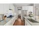 Modern kitchen featuring stainless steel appliances, granite countertops, and sleek white cabinetry at 1906 Se 28Th Pl, Ocala, FL 34471
