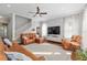 Spacious living room with modern ceiling fan, large screen television, and stylish leather seating at 1906 Se 28Th Pl, Ocala, FL 34471
