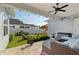 Covered patio area with outdoor seating, ceiling fan, string lights, and a view of the fenced backyard at 1906 Se 28Th Pl, Ocala, FL 34471