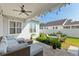 Covered patio with comfortable seating, string lights, and a view of the backyard with a fire pit area at 1906 Se 28Th Pl, Ocala, FL 34471