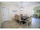 Inviting dining room boasts a contemporary light fixture and dining table with upholstered chairs at 2406 Se 40Th Street Rd, Ocala, FL 34480