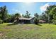 Charming home featuring a screened porch, lush landscaping, and a spacious yard at 2406 Se 40Th Street Rd, Ocala, FL 34480