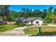 Charming single-story home featuring well-maintained lawn, stone accents and a long driveway at 2406 Se 40Th Street Rd, Ocala, FL 34480