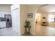 Transitional hallway provides access to the kitchen with stainless steel appliances and a view into a living area at 2406 Se 40Th Street Rd, Ocala, FL 34480