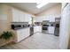 Modern kitchen with white cabinets, stainless steel appliances, and light wood floors at 2406 Se 40Th Street Rd, Ocala, FL 34480