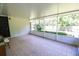 Spacious screened-in lanai with tile flooring and a view of the lush backyard at 2406 Se 40Th Street Rd, Ocala, FL 34480