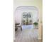 Living area with arched doorway leads to a room showcasing stylish decor and light, airy ambiance at 2406 Se 40Th Street Rd, Ocala, FL 34480