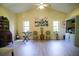Spacious living room features vaulted ceilings, artful decor, and light wood-look floors at 2406 Se 40Th Street Rd, Ocala, FL 34480