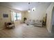 Bright living room features wood floors, vaulted ceiling, large window, and modern furnishings at 2406 Se 40Th Street Rd, Ocala, FL 34480