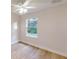 Bright bedroom featuring wood-look flooring, neutral walls, and a bright window overlooking the yard at 24128 Sw South Lakes Ct, Dunnellon, FL 34431
