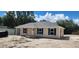 Charming home showcasing neutral siding, black shutters, new roof, and convenient attached carport at 24128 Sw South Lakes Ct, Dunnellon, FL 34431