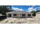 Charming home showcasing neutral siding, black shutters, new roof, and convenient attached carport at 24128 Sw South Lakes Ct, Dunnellon, FL 34431