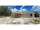 Exterior shot showcasing a covered patio perfect for outdoor relaxation at 24146 Sw South Lakes Ct, Dunnellon, FL 34431