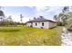 View of the back of a white single-story house with grass and minimal landscaping at 2438 Sw 165Th Street Rd, Ocala, FL 34473