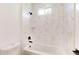 Modern bathroom with a white tub, black fixtures, and white marble-patterned tiles at 2438 Sw 165Th Street Rd, Ocala, FL 34473