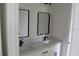 Bathroom featuring dual sinks with modern fixtures and rectangular mirrors above at 2438 Sw 165Th Street Rd, Ocala, FL 34473