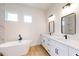 Luxurious bathroom with a freestanding tub, double vanity, and white cabinets at 2438 Sw 165Th Street Rd, Ocala, FL 34473