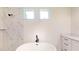 Bathroom featuring a standalone tub, marble tile, and dual windows at 2438 Sw 165Th Street Rd, Ocala, FL 34473