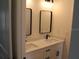 Bathroom featuring dual sinks with modern fixtures and rectangular mirrors above at 2438 Sw 165Th Street Rd, Ocala, FL 34473