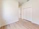This bedroom features neutral walls, trim, and a wood-look floor complemented by a double door closet at 2438 Sw 165Th Street Rd, Ocala, FL 34473