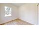 A bedroom features wood flooring and a bright sunny window at 2438 Sw 165Th Street Rd, Ocala, FL 34473