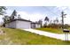 View of modern single-story house featuring a long driveway, garage, and mailbox at 2438 Sw 165Th Street Rd, Ocala, FL 34473