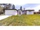 Single-story house with modern architectural design featuring a long driveway, garage, and manicured lawn at 2438 Sw 165Th Street Rd, Ocala, FL 34473
