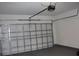 Spacious garage with a grey floor and white walls, including a modern garage door and opener at 2438 Sw 165Th Street Rd, Ocala, FL 34473
